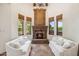 Bright living room with a stone fireplace, large windows, and cozy couches for relaxing at 8329 N Ridgeview Dr, Paradise Valley, AZ 85253