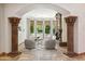Elegant living room with archway, fireplace, and bay window offering picturesque views at 8329 N Ridgeview Dr, Paradise Valley, AZ 85253