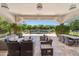 Inviting covered patio area with comfortable seating, offering views of the serene pool and lush landscaping at 8329 N Ridgeview Dr, Paradise Valley, AZ 85253