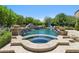 Inviting pool area showcasing a spa and waterfall feature, complemented by well-maintained landscaping at 8329 N Ridgeview Dr, Paradise Valley, AZ 85253