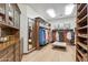 Spacious walk-in closet with custom shelving, drawers, mirrors, and a central ottoman at 8329 N Ridgeview Dr, Paradise Valley, AZ 85253