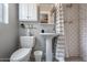 Bright bathroom with white subway tile, vanity sink, and overhead cabinet at 836 W Mitchell Dr, Phoenix, AZ 85013