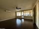 Large bedroom with sliding door closet, dark wood floors, and an enclosed patio area at 836 W Mitchell Dr, Phoenix, AZ 85013