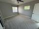 Bedroom with gray walls, plush carpet, and windows providing natural light at 836 W Mitchell Dr, Phoenix, AZ 85013