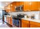Bright kitchen showcasing stainless steel appliances, stylish backsplash, and ample counter space at 836 W Mitchell Dr, Phoenix, AZ 85013