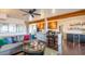 Cozy living room featuring hardwood floors, exposed beams, and seamless flow to the kitchen at 836 W Mitchell Dr, Phoenix, AZ 85013