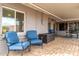 Inviting covered patio with brick flooring, lounge chairs, and an outdoor dining area at 836 W Mitchell Dr, Phoenix, AZ 85013