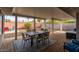 Relaxing covered patio area with brick flooring, outdoor dining, and lounge seating at 836 W Mitchell Dr, Phoenix, AZ 85013