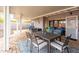 Covered outdoor patio with a dining set, lounge chairs, and privacy wall at 836 W Mitchell Dr, Phoenix, AZ 85013