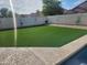 Private backyard featuring artificial turf, string lights and block wall at 9252 W Carol Ave, Peoria, AZ 85345