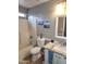 Bright bathroom features a shower-tub combination, granite counter, and white vanity with beach-themed art at 9252 W Carol Ave, Peoria, AZ 85345