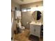 Neutral bathroom with tile floors, white vanity, round mirror, and wall cabinet at 9252 W Carol Ave, Peoria, AZ 85345