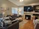 Comfortable living room with vaulted ceilings, a cozy fireplace, and hardwood floors at 9252 W Carol Ave, Peoria, AZ 85345