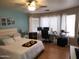 Spacious bedroom features a ceiling fan, ensuite desk and a large window for natural light at 9252 W Carol Ave, Peoria, AZ 85345