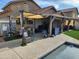 Covered backyard patio with outdoor seating and entertainment setup for relaxation at 9252 W Carol Ave, Peoria, AZ 85345
