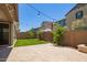 Backyard features artificial turf and a brick paver patio with bistro lighting above at 1081 E Armstrong Way, Chandler, AZ 85286