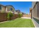 This backyard features artificial turf, mature trees, and a private brick wall at 1081 E Armstrong Way, Chandler, AZ 85286