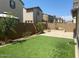 Great backyard featuring artificial turf, a paver patio, and a surrounding privacy fence at 1081 E Armstrong Way, Chandler, AZ 85286
