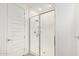Modern bathroom featuring a walk-in shower with a glass door and white subway tile at 1081 E Armstrong Way, Chandler, AZ 85286