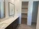 Elegant bathroom with double sinks, quartz countertops, and access to a walk-in closet at 1081 E Armstrong Way, Chandler, AZ 85286