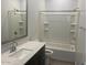 Clean bathroom featuring quartz countertops, a modern sink, and a shower-tub combination at 1081 E Armstrong Way, Chandler, AZ 85286