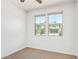 Bright bedroom with carpet, a ceiling fan, and two windows offering a neighborhood view at 1081 E Armstrong Way, Chandler, AZ 85286