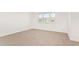Bright bedroom with a large window, carpet, and modern design at 1081 E Armstrong Way, Chandler, AZ 85286