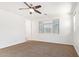 Bright bedroom with a ceiling fan, neutral carpeting, and a large window offering plenty of natural light at 1081 E Armstrong Way, Chandler, AZ 85286