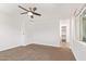 Comfortable bedroom with neutral carpet, a ceiling fan, a large window and a closet at 1081 E Armstrong Way, Chandler, AZ 85286