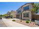Two-story home with a brown two-car garage, desert landscaping, and neutral paint scheme at 1081 E Armstrong Way, Chandler, AZ 85286