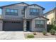 Charming two-story home with a well-maintained front yard and attached two-car garage at 1081 E Armstrong Way, Chandler, AZ 85286