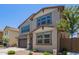 Two-story home with a brown two-car garage, desert landscaping, and neutral paint scheme at 1081 E Armstrong Way, Chandler, AZ 85286