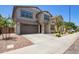 Two-story home with a brown two-car garage, desert landscaping, and neutral paint scheme at 1081 E Armstrong Way, Chandler, AZ 85286