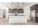 Modern kitchen featuring stainless steel appliances, dark cabinetry, white countertops, and pendant lighting above the island at 1081 E Armstrong Way, Chandler, AZ 85286