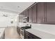 Kitchen showcasing dark wood cabinets, stainless steel appliances, white countertops and a subway tile backsplash at 1081 E Armstrong Way, Chandler, AZ 85286