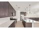 Well-equipped kitchen featuring stainless steel appliances, stylish cabinetry, and a large island with modern lighting fixtures at 1081 E Armstrong Way, Chandler, AZ 85286