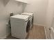 Functional laundry room with modern washer and dryer units and tile flooring at 1081 E Armstrong Way, Chandler, AZ 85286