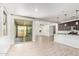 Spacious open-concept living room with tile flooring and access to a covered patio through sliding glass doors at 1081 E Armstrong Way, Chandler, AZ 85286