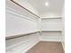 Spacious walk-in closet with multiple shelves and rods for ample storage space at 1081 E Armstrong Way, Chandler, AZ 85286