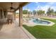 This inviting backyard has a pool, patio, and grassy area for endless outdoor fun and relaxation at 10909 W Chase Ln, Avondale, AZ 85323