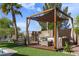 Charming backyard patio with a pergola, comfortable seating, and a lush lawn, ideal for outdoor living and entertaining at 10909 W Chase Ln, Avondale, AZ 85323