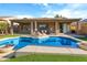 Inviting backyard oasis with a sparkling pool, lounge chairs, and a covered patio, perfect for relaxation and outdoor entertaining at 10909 W Chase Ln, Avondale, AZ 85323