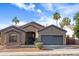 Charming single-Gathering home with a well-manicured lawn, mature trees, and attached two car garage at 10909 W Chase Ln, Avondale, AZ 85323