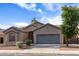 Inviting single-Gathering home with a well-manicured lawn, mature trees, and attached two car garage at 10909 W Chase Ln, Avondale, AZ 85323