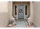 Welcoming front entrance with a decorative door, stylish wreath, and charming accents, enhancing curb appeal at 10909 W Chase Ln, Avondale, AZ 85323