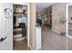 Organized hallway closet with storage solutions, and view of tile flooring and a view into a well-lit living space at 10909 W Chase Ln, Avondale, AZ 85323