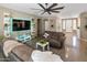 Spacious living room with tile flooring, neutral decor, and large sofas, creating a comfortable and inviting atmosphere at 10909 W Chase Ln, Avondale, AZ 85323
