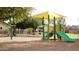 Community playground featuring a covered play structure, slide, and swings for endless fun and recreation at 10909 W Chase Ln, Avondale, AZ 85323