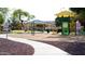 Community playground featuring a play structure and swings, perfect for outdoor activities at 10909 W Chase Ln, Avondale, AZ 85323