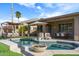 Inviting backyard pool with a covered lounge area, sun umbrella, and outdoor dining for relaxing and entertaining at 10909 W Chase Ln, Avondale, AZ 85323